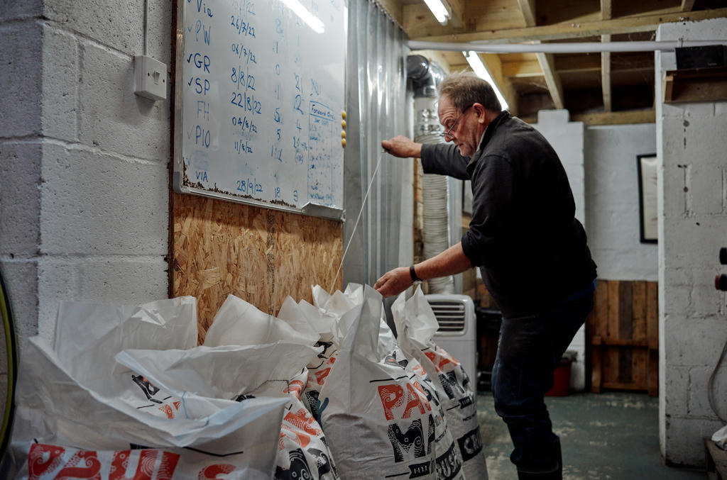 Keith opening a sack of grains at Dynamite Valley Brewing Co.
